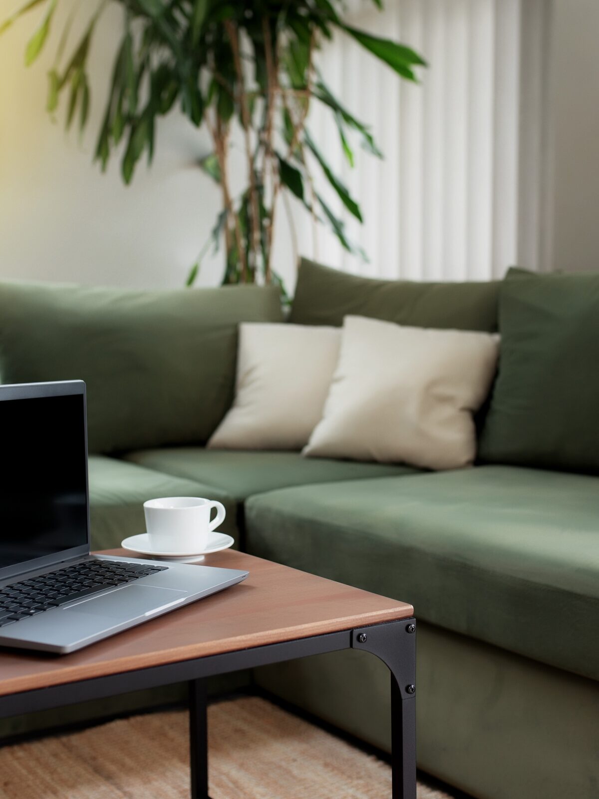 A relaxed United Stay lounge area with a green sofa and coffee table